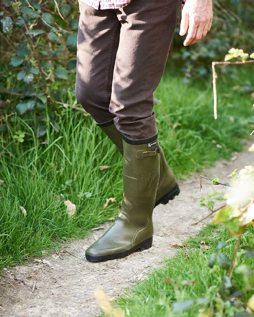 Khaki coloured Aigle Benyl Wellington Boots on grassy background #colour_khaki