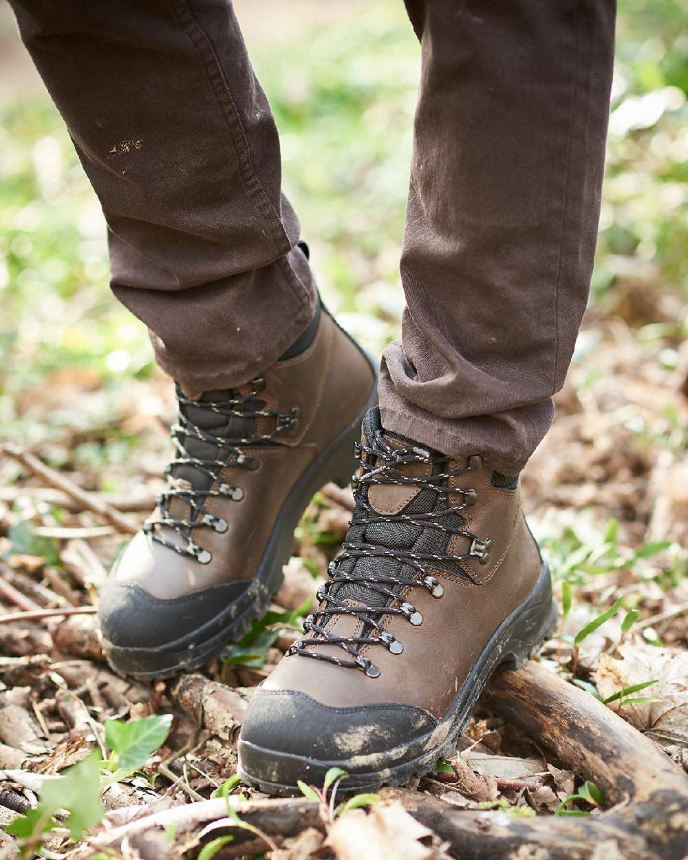 Dark Brown coloured Aigle Laforse Boots on forest background #colour_dark-brown