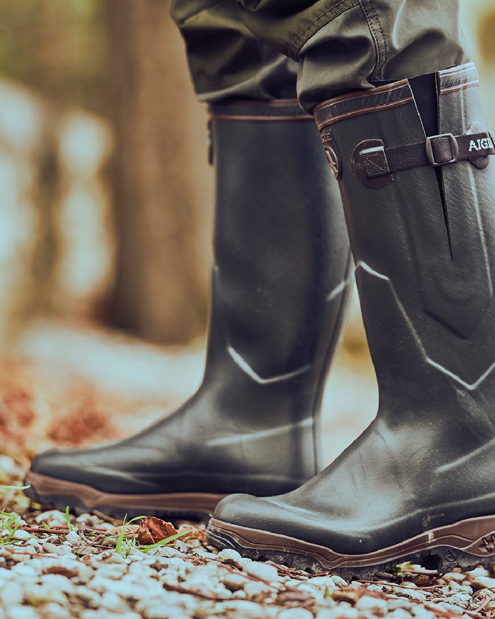 Brun coloured Aigle Parcours 2 ISO Wellington Boots on forest background #colour_brun