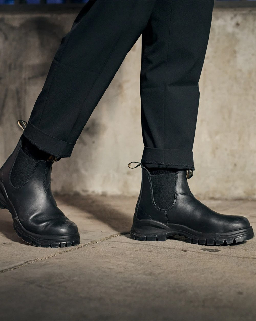 Black coloured Blundstone 2240 Black Leather Chelsea Boots on wall background #colour_black