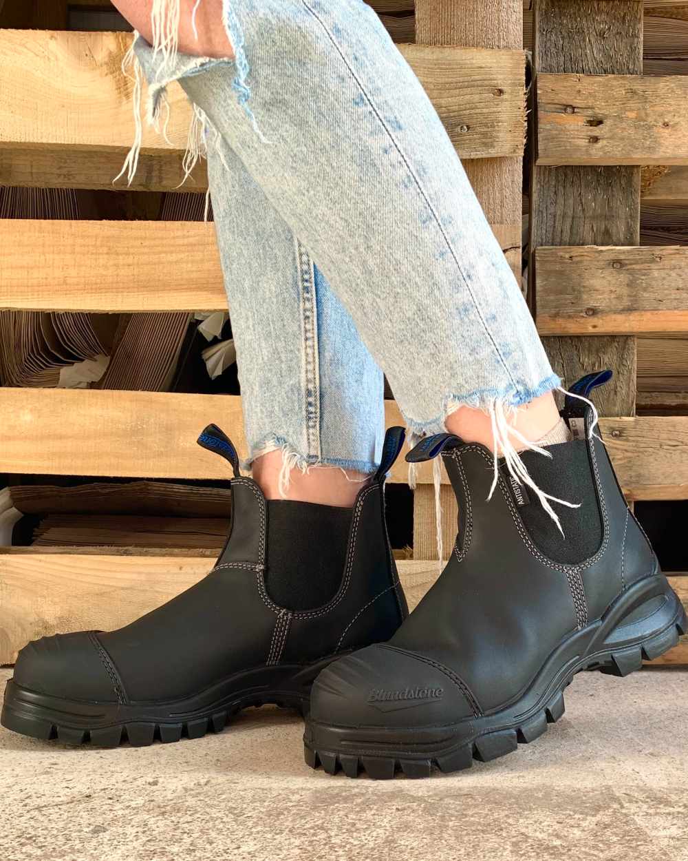 Black coloured Blundstone 910 Black Platinum Safety Boots on street background #colour_black
