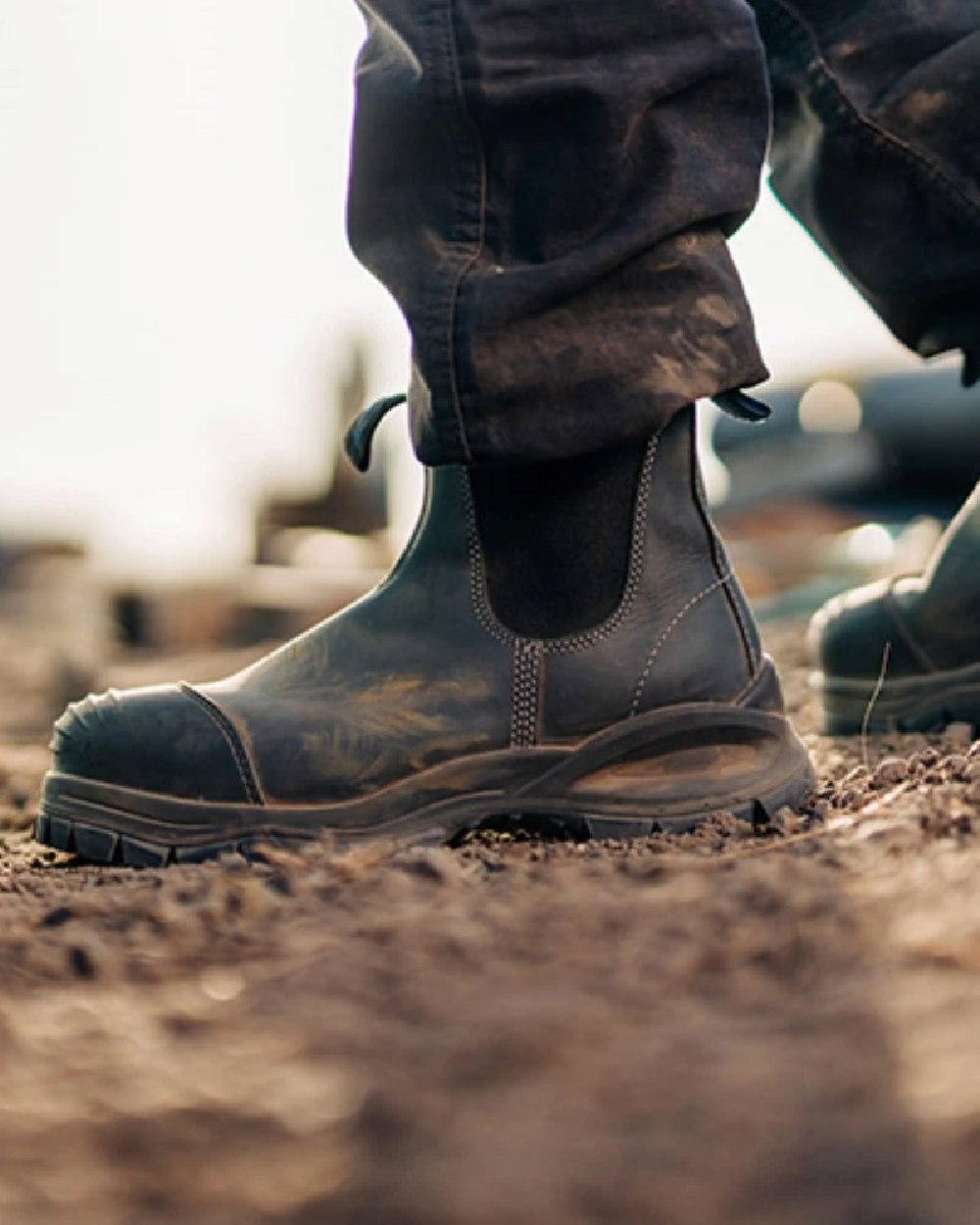 Black coloured Blundstone 910 Black Platinum Safety Boots on soil background #colour_black