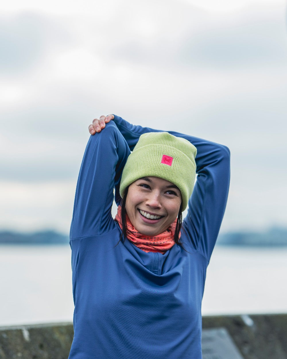 Sheen Yellow Coloured Buff CrossKnit Beanie on blurry background #colour_sheen-yellow