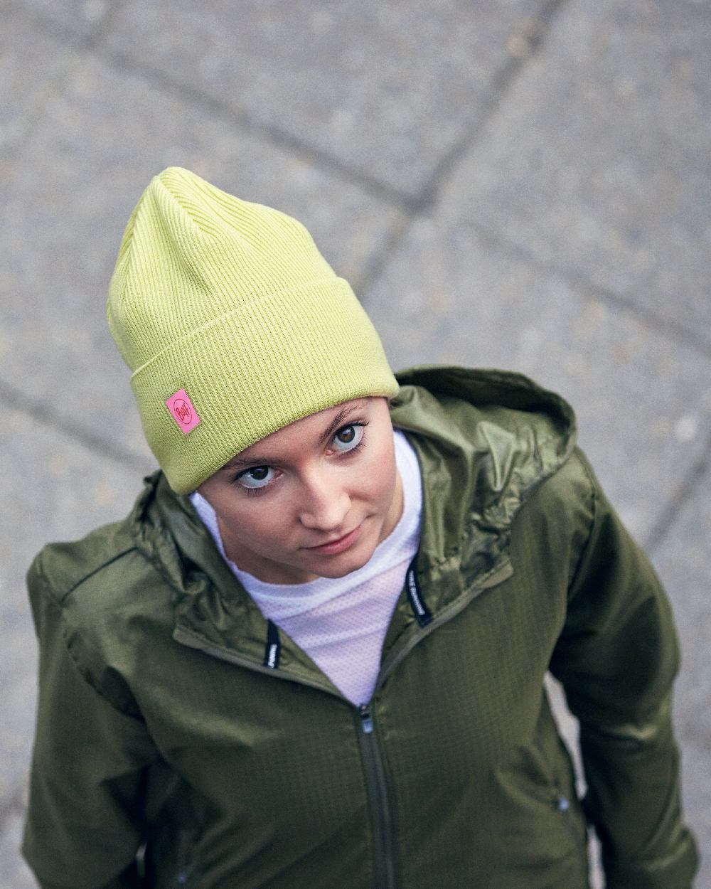 Sheen Yellow Coloured Buff CrossKnit Beanie on street background #colour_sheen-yellow