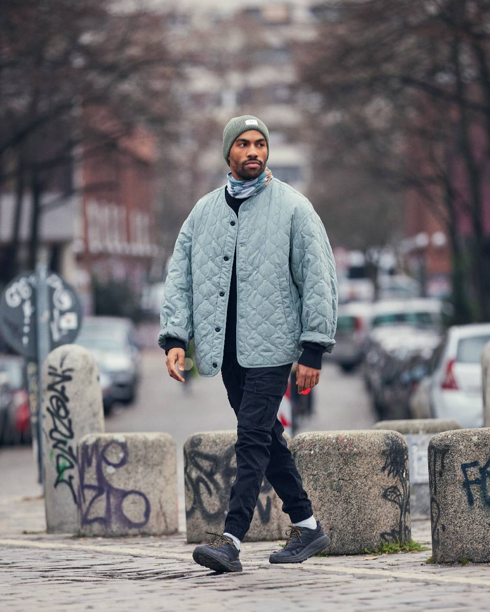 Silversage Coloured Buff Drisk Knitted Beanie on street background #colour_silversage