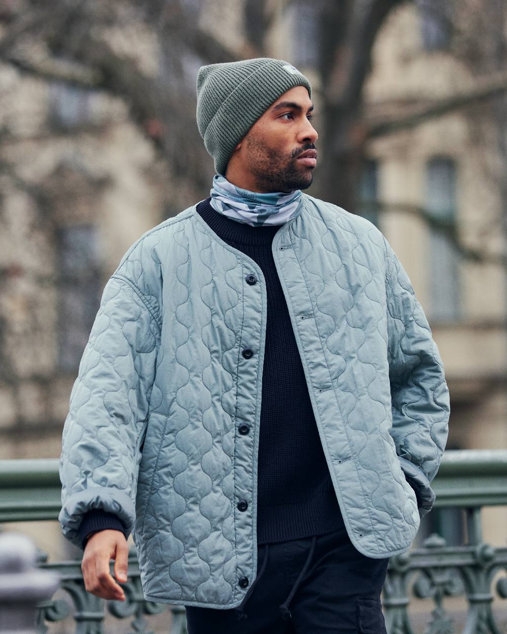 Silversage Coloured Buff Drisk Knitted Beanie on blurry background #colour_silversage