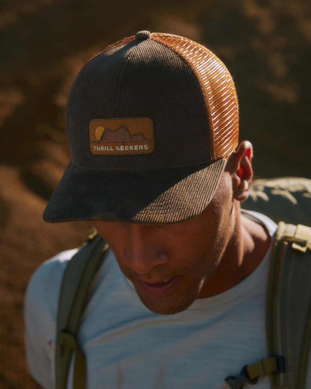 Brown Coloured Buff Explore Trucker Cap on ground background #colour_brown