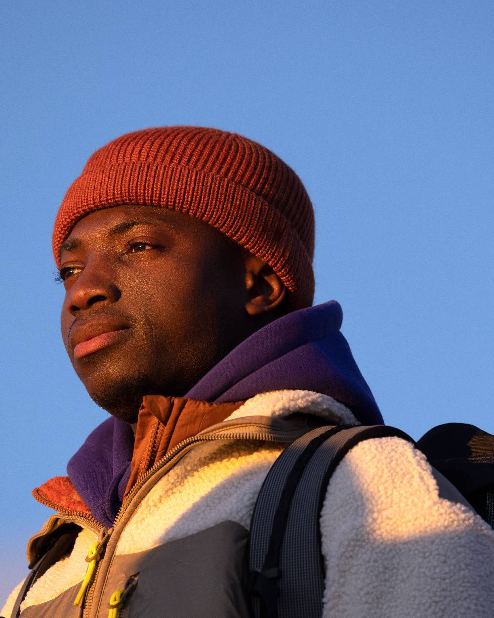 Cinnamon Coloured Buff Knitted Ervin Beanie on sky background #colour_cinnamon