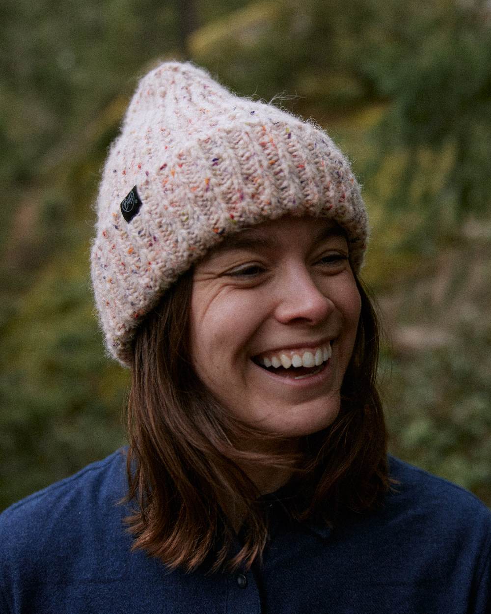 White Coloured Buff Kim Knitted Fleece Beanie on blurry background #colour_white