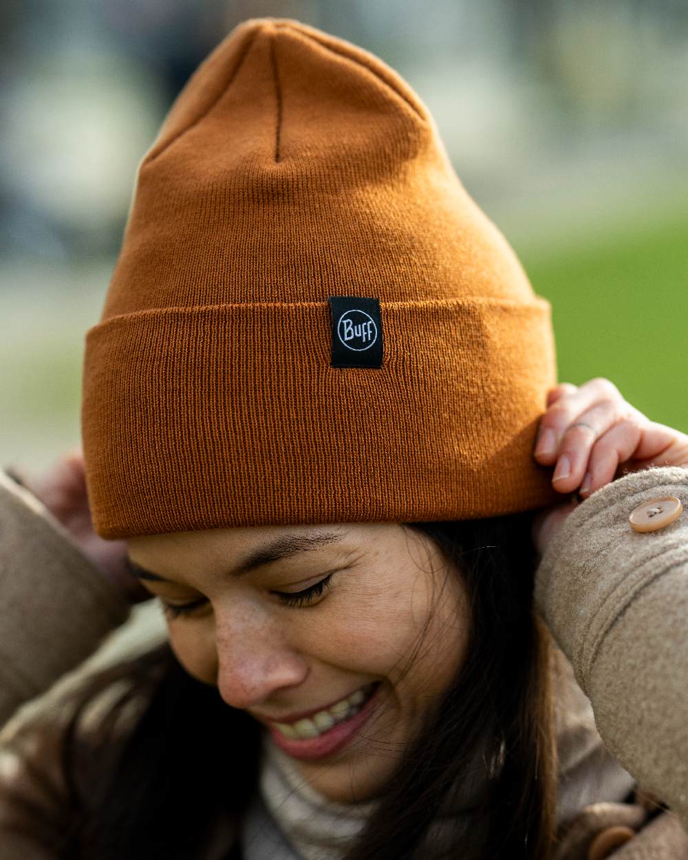 Copper Coloured Buff Linon Knitted Beanie on blurry background #colour_copper