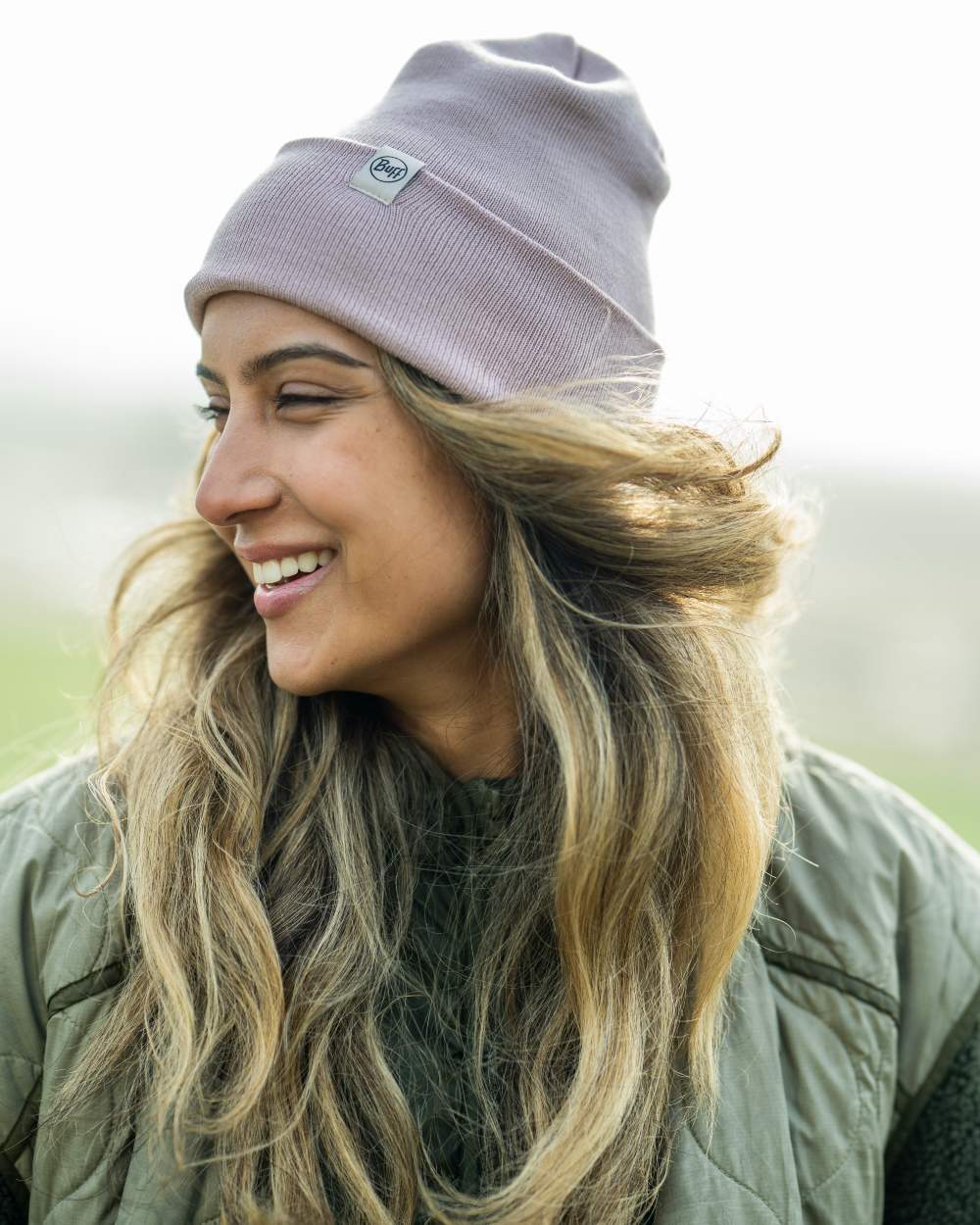 Rosewood Coloured Buff Linon Knitted Beanie on blurry background #colour_rosewood