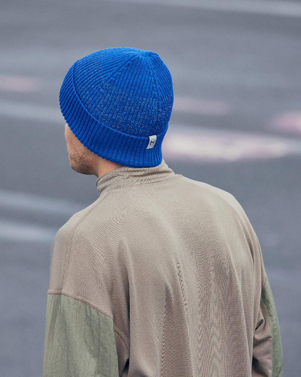 Cobalt Coloured Buff Merino Active Beanie on blurry background #colour_cobalt