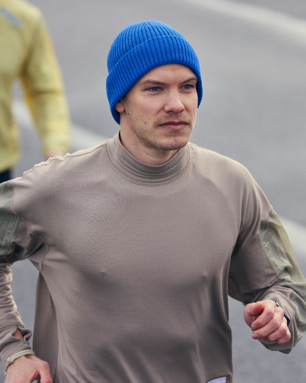 Cobalt Coloured Buff Merino Active Beanie on blurry background #colour_cobalt