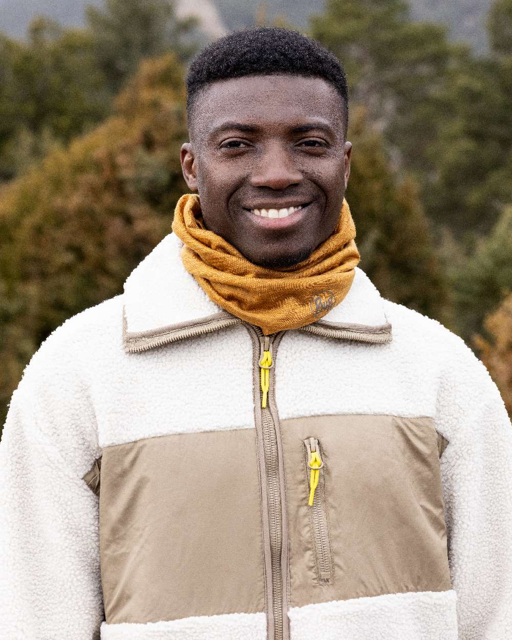Mustard Coloured Buff Merino Lightweight Neck Warmer on outdoor background #colour_mustard