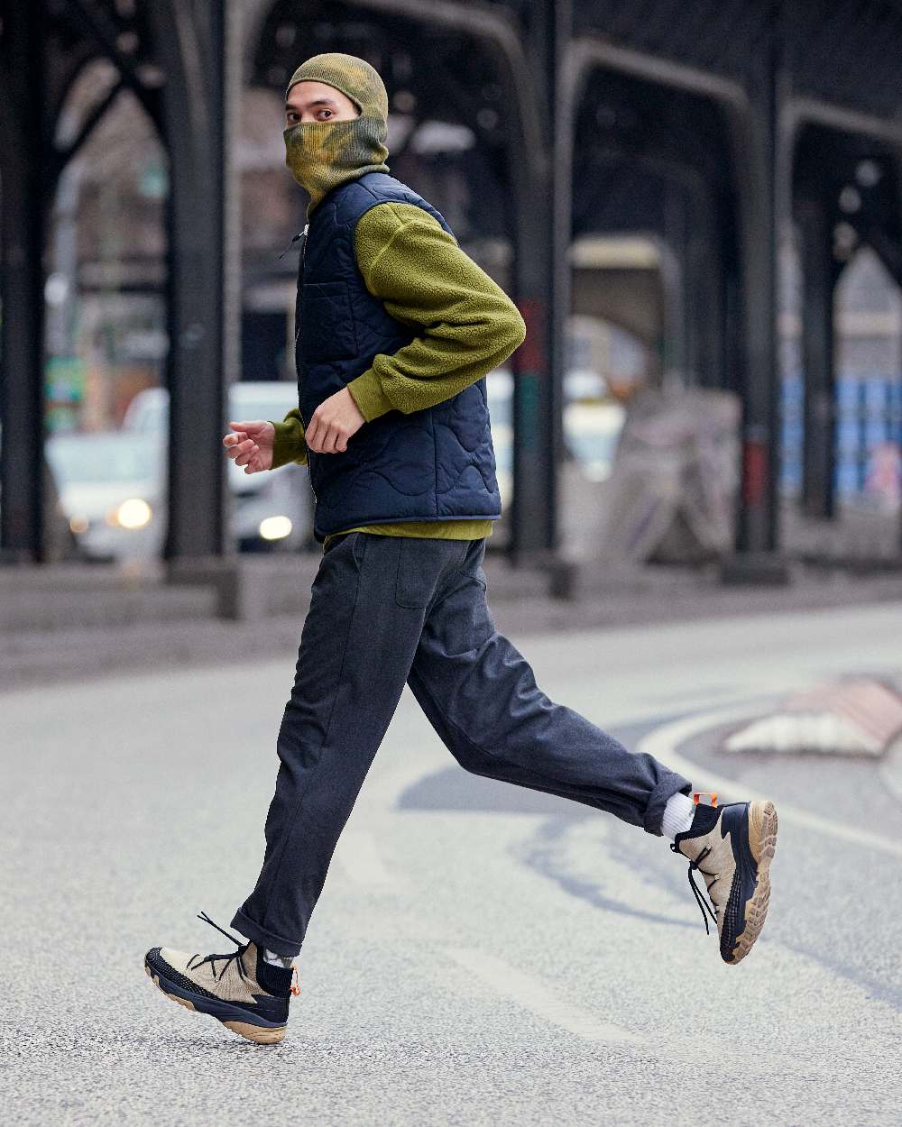 Khaki Coloured Buff Nilan Knitted Balaclava on blurry background #colour_khaki