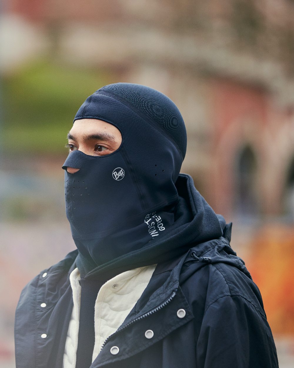 Black Coloured Buff Windproof Solid Balaclava on blurry background #colour_black