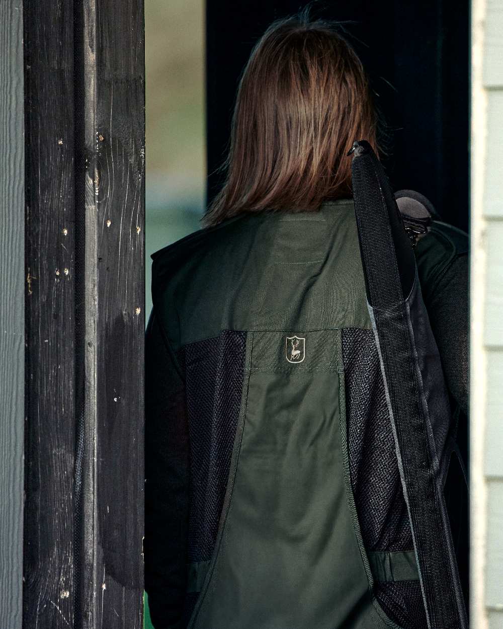 Timber coloured Deerhunter Atlas Mesh Shooting Waistcoat on blurry background #colour_timber