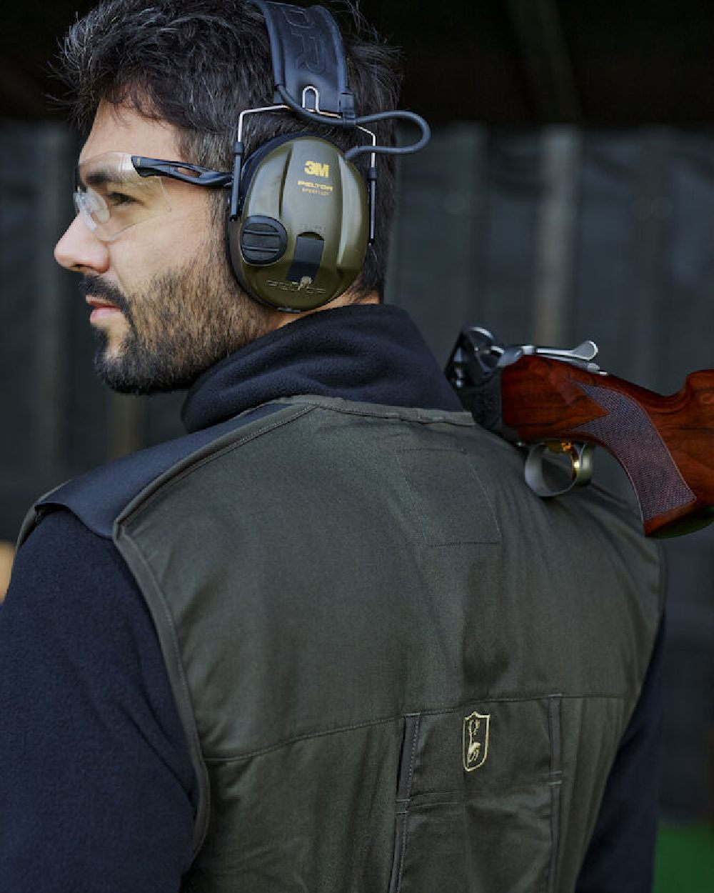 Timber coloured Deerhunter Atlas Shooting Waistcoat on blurry background #colour_timber