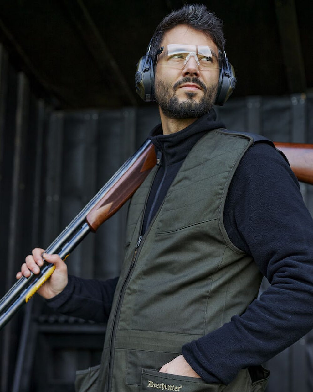 Timber coloured Deerhunter Atlas Shooting Waistcoat on blurry background #colour_timber