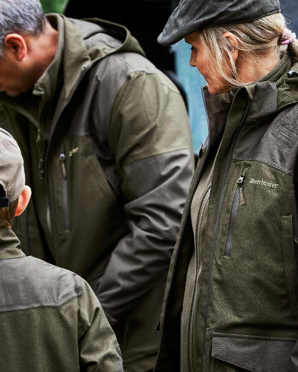 Olive Green Melange Coloured Deerhunter Chasse Jacket on blurry background #colour_olive-green-melange