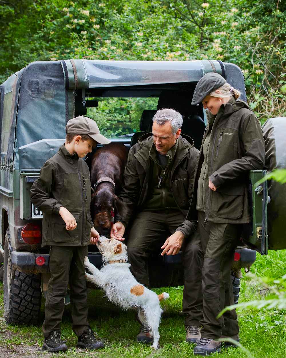 Olive Green Melange Coloured Deerhunter Chasse Jacket on forest background #colour_olive-green-melange