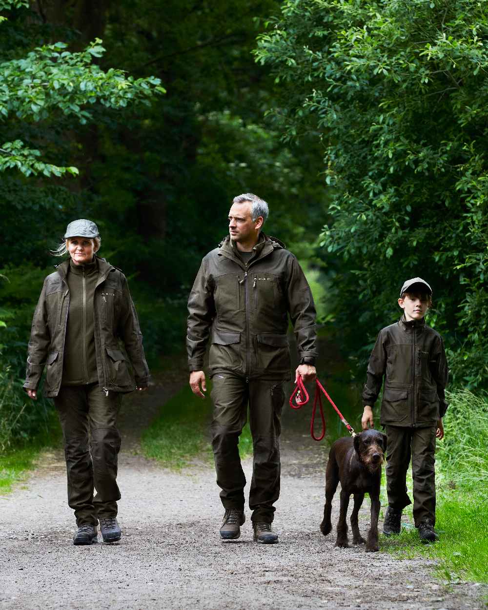Olive Night Melange coloured Deerhunter Chasse Trousers on tree background #colour_olive-night-melange