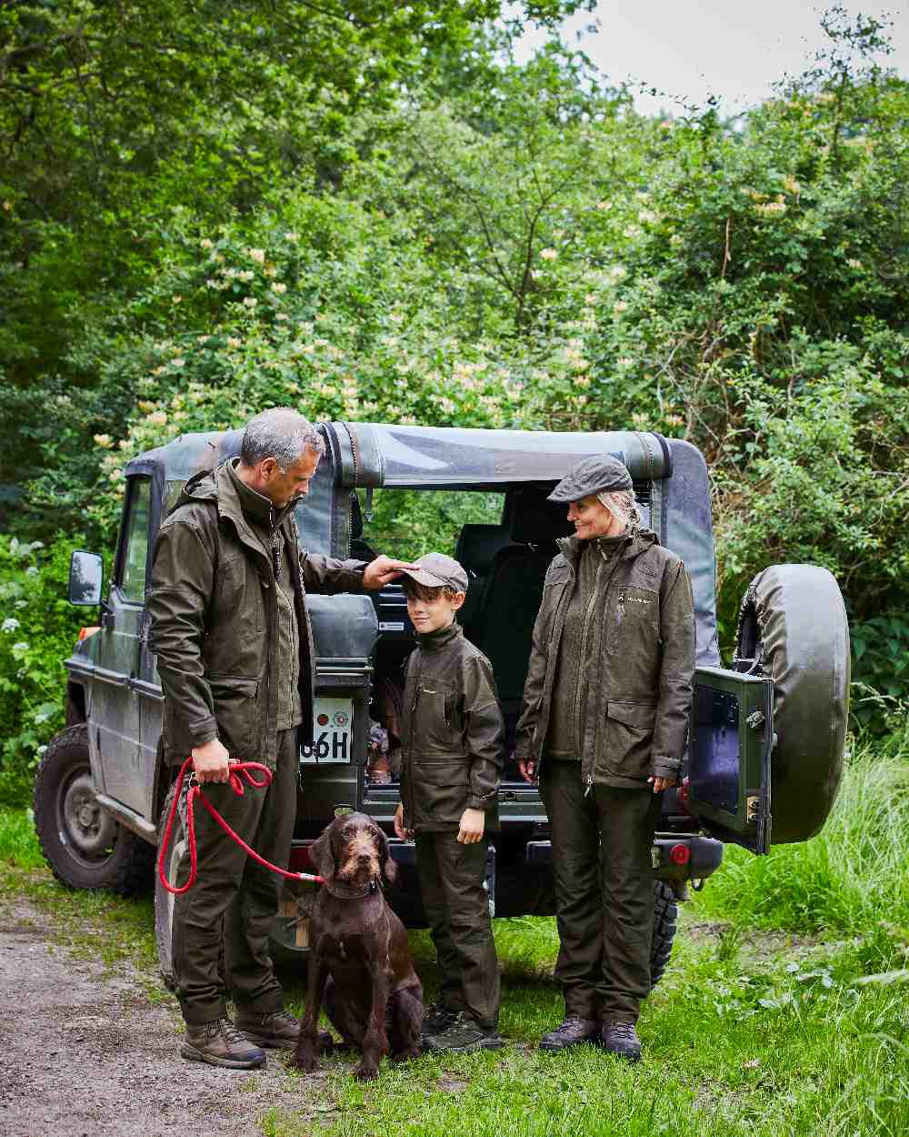 Olive Night Melange coloured Deerhunter Chasse Trousers on tree background #colour_olive-night-melange