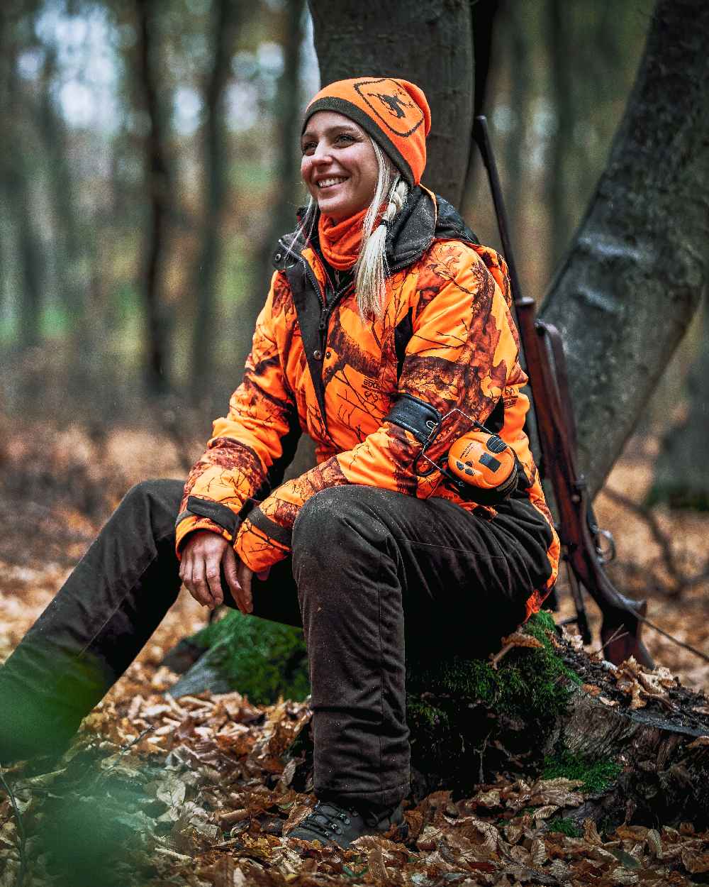 Orange Green coloured Deerhunter Cumberland Reversible Beanie on forest background #colour_orange-green