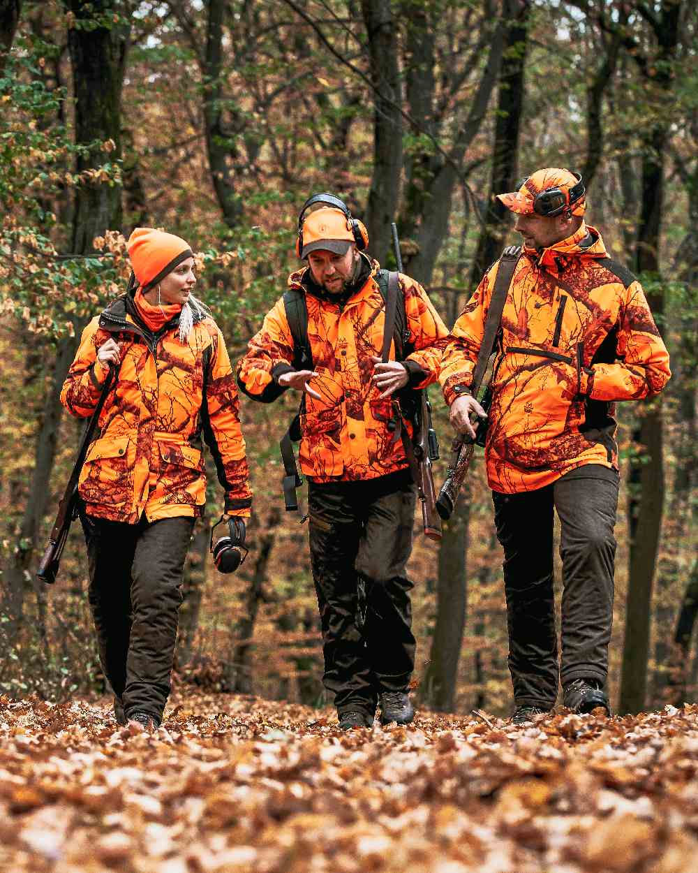 Orange Green coloured Deerhunter Cumberland Reversible Beanie on forest background #colour_orange-green