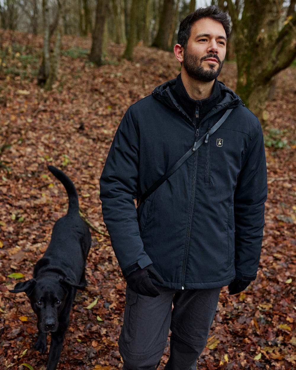 Dark Blue coloured Deerhunter Denver Winter Jacket on forest background #colour_dark-blue