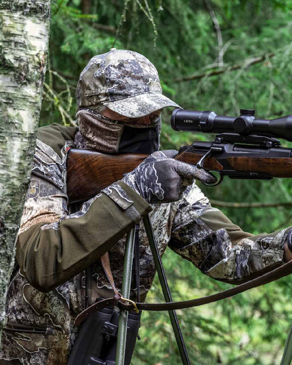 Realtree Excape coloured Deerhunter Excape Facemask on forest background #colour_realtree-excape