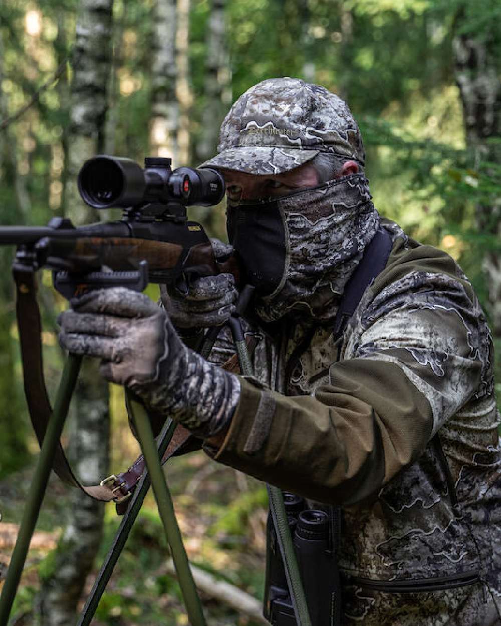 Realtree Excape coloured Deerhunter Excape Facemask on forest background #colour_realtree-excape