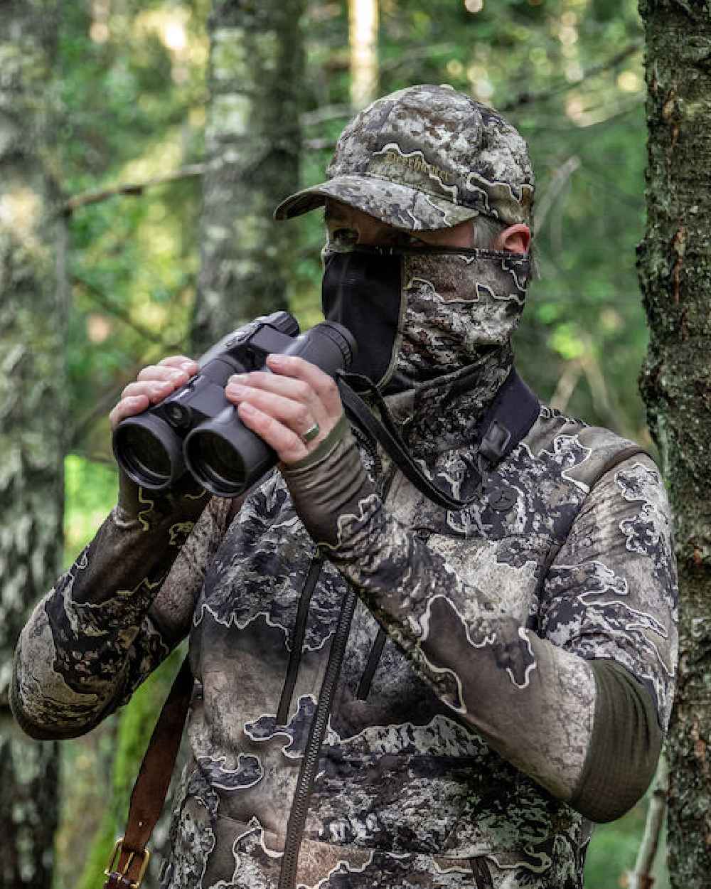 Realtree Excape coloured Deerhunter Excape Facemask on forest background #colour_realtree-excape