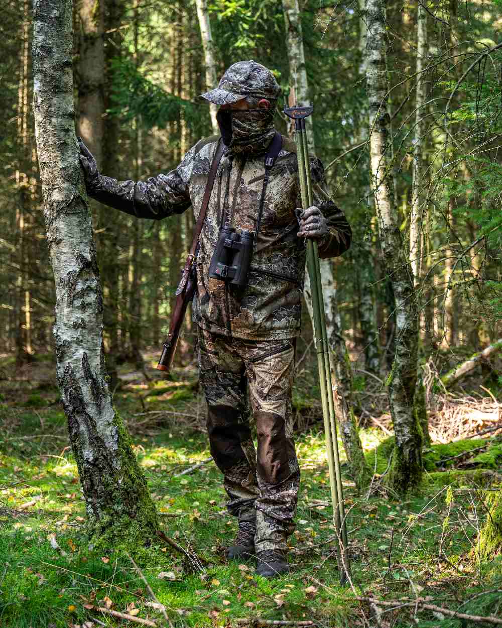 Realtree Excape coloured Deerhunter Excape Light Trousers on forest background #colour_realtree-excape