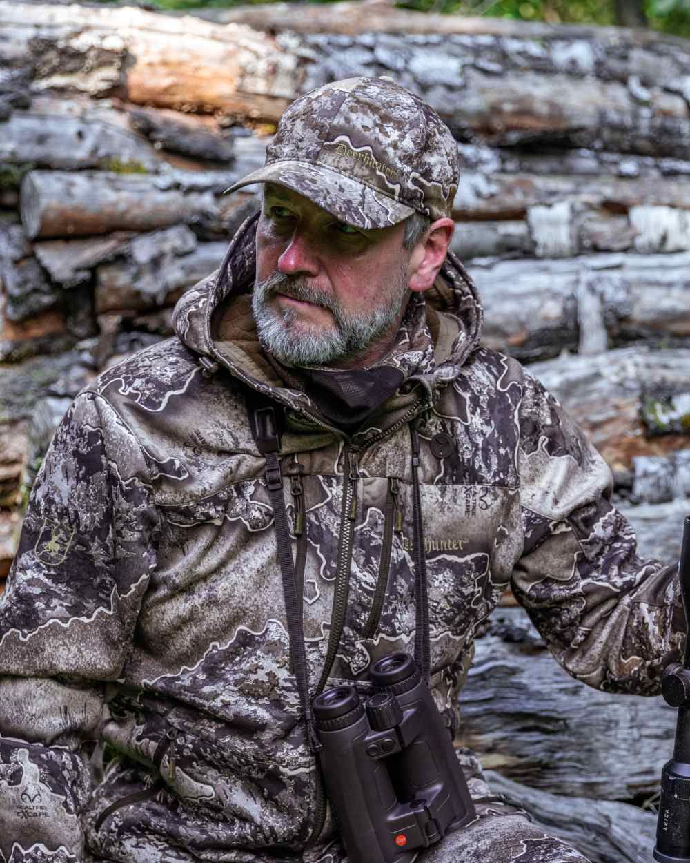 Realtree Excape coloured Deerhunter Excape Softshell Jacket on wood background #colour_realtree-excape