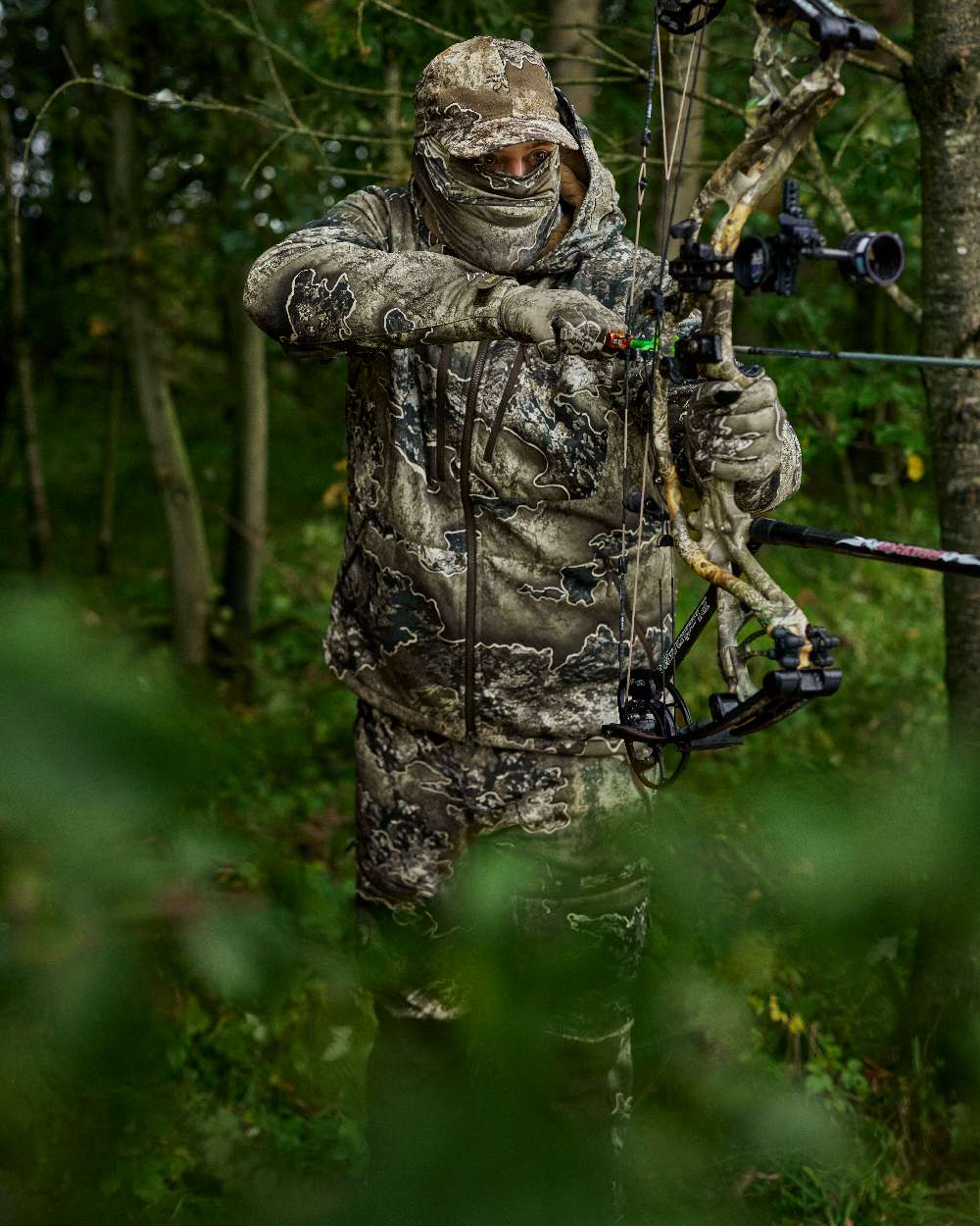 Realtree Excape coloured Deerhunter Excape Softshell Jacket on forest background #colour_realtree-excape
