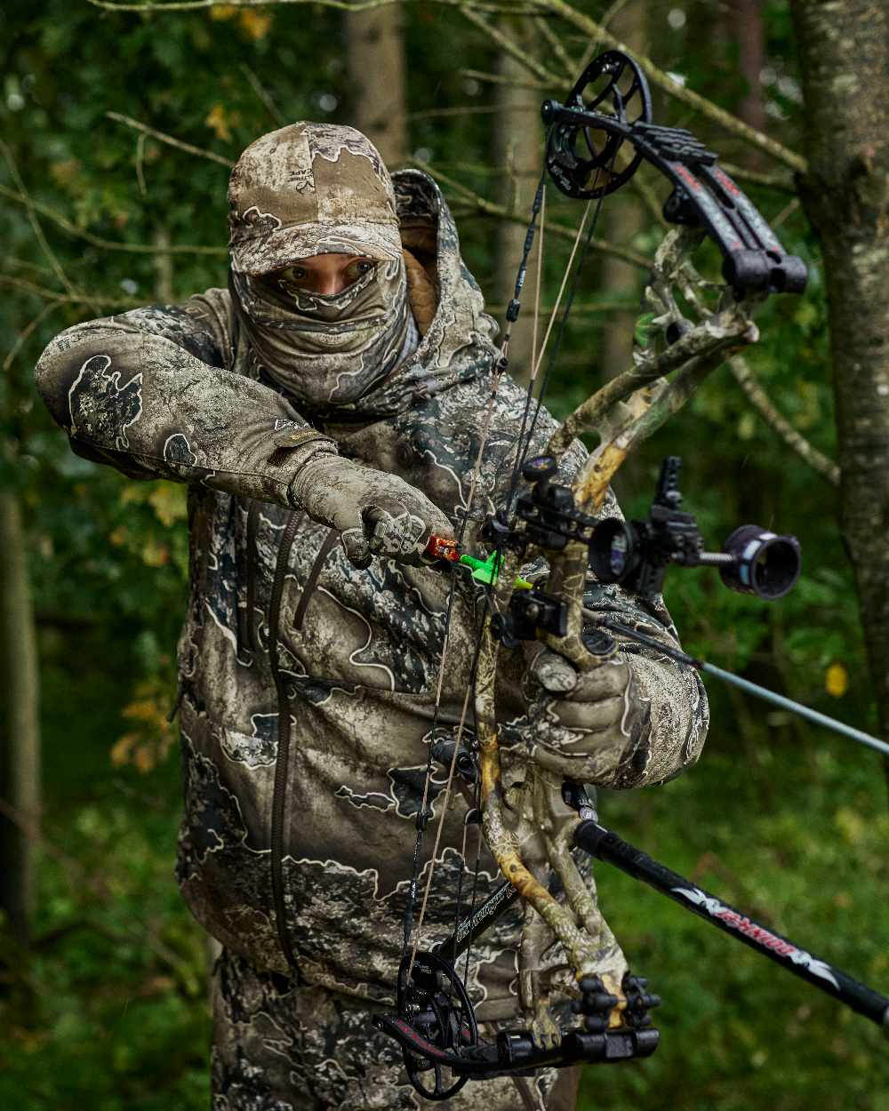 Realtree Excape coloured Deerhunter Excape Softshell Jacket on forest background #colour_realtree-excape