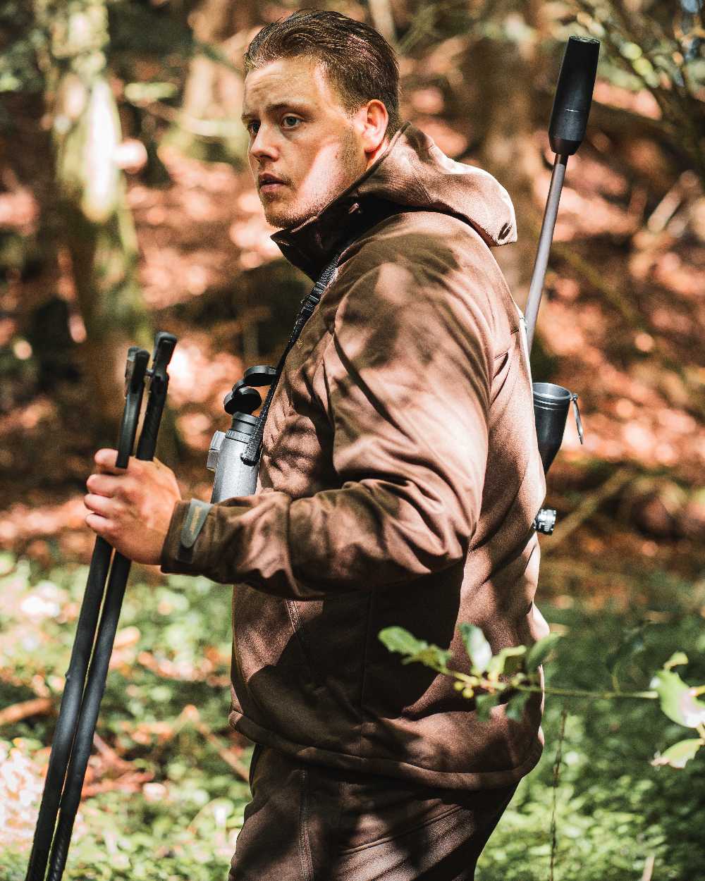 Art Green coloured Deerhunter Excape Softshell Trousers on forest background #colour_art-green
