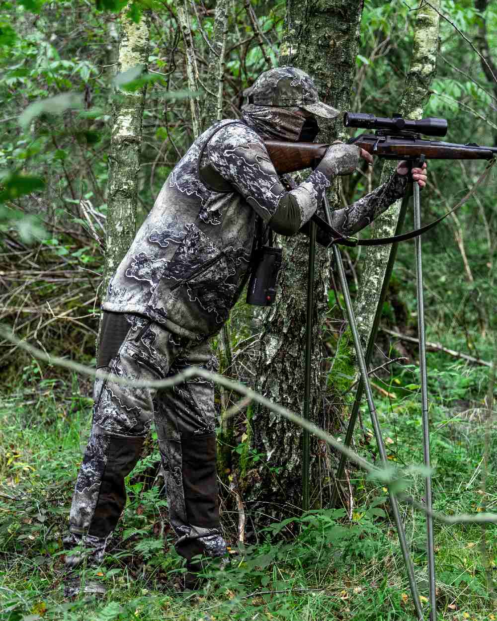 Realtree Excape coloured Deerhunter Excape Softshell Trousers on forest background #colour_realtree-excape