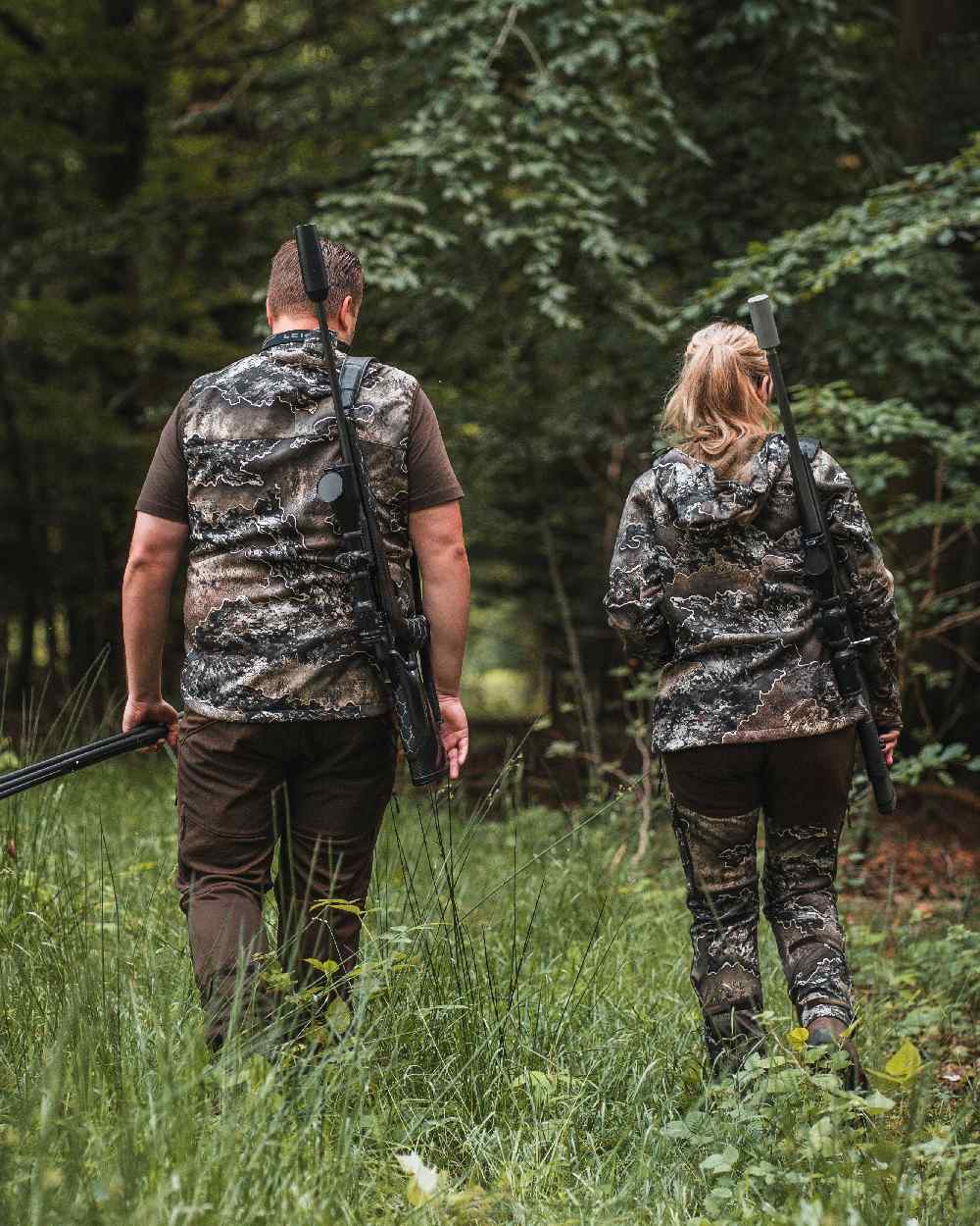 Realtree Excape coloured Deerhunter Excape Softshell Waistcoat on forest background #colour_realtree-excape