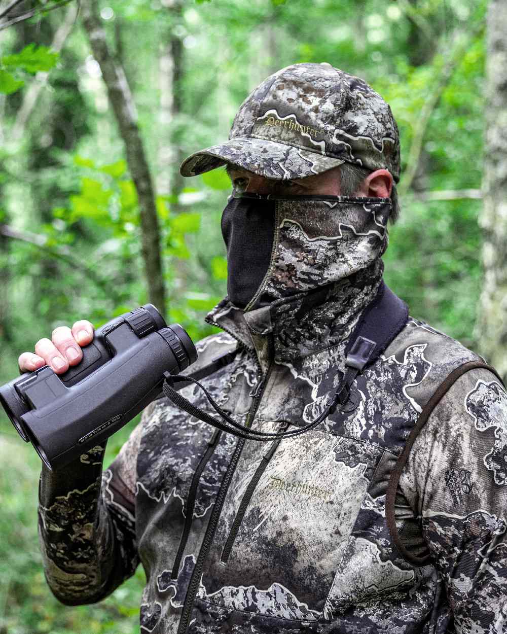 Realtree Excape coloured Deerhunter Excape Softshell Waistcoat on forest background #colour_realtree-excape