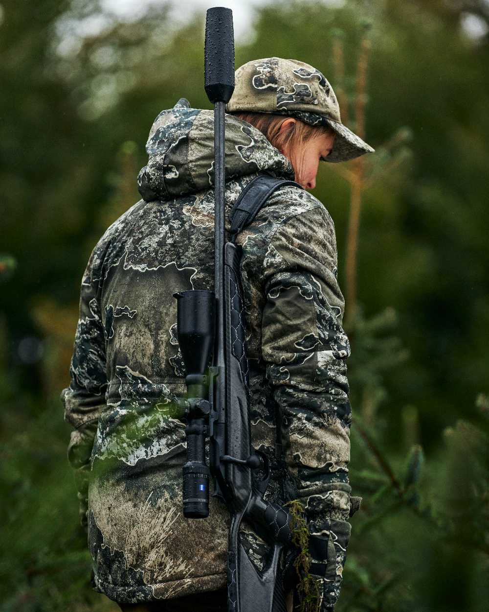 Realtree Excape coloured Deerhunter Excape Winter Cap on blurry background #colour_realtree-excape