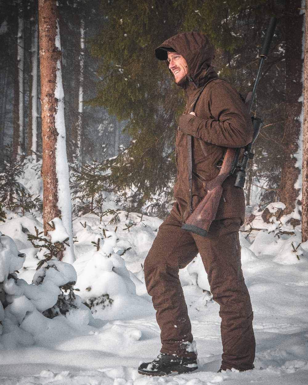 Art Green coloured Deerhunter Excape Winter Waterproof Trousers on snow background #colour_art-green