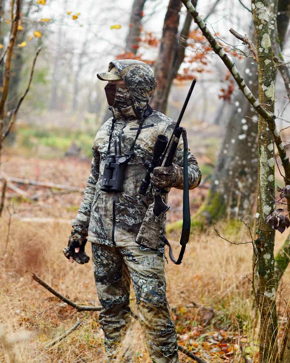 Realtree Excape coloured Deerhunter Excape Winter Waterproof Trousers on forest background #colour_realtree-excape