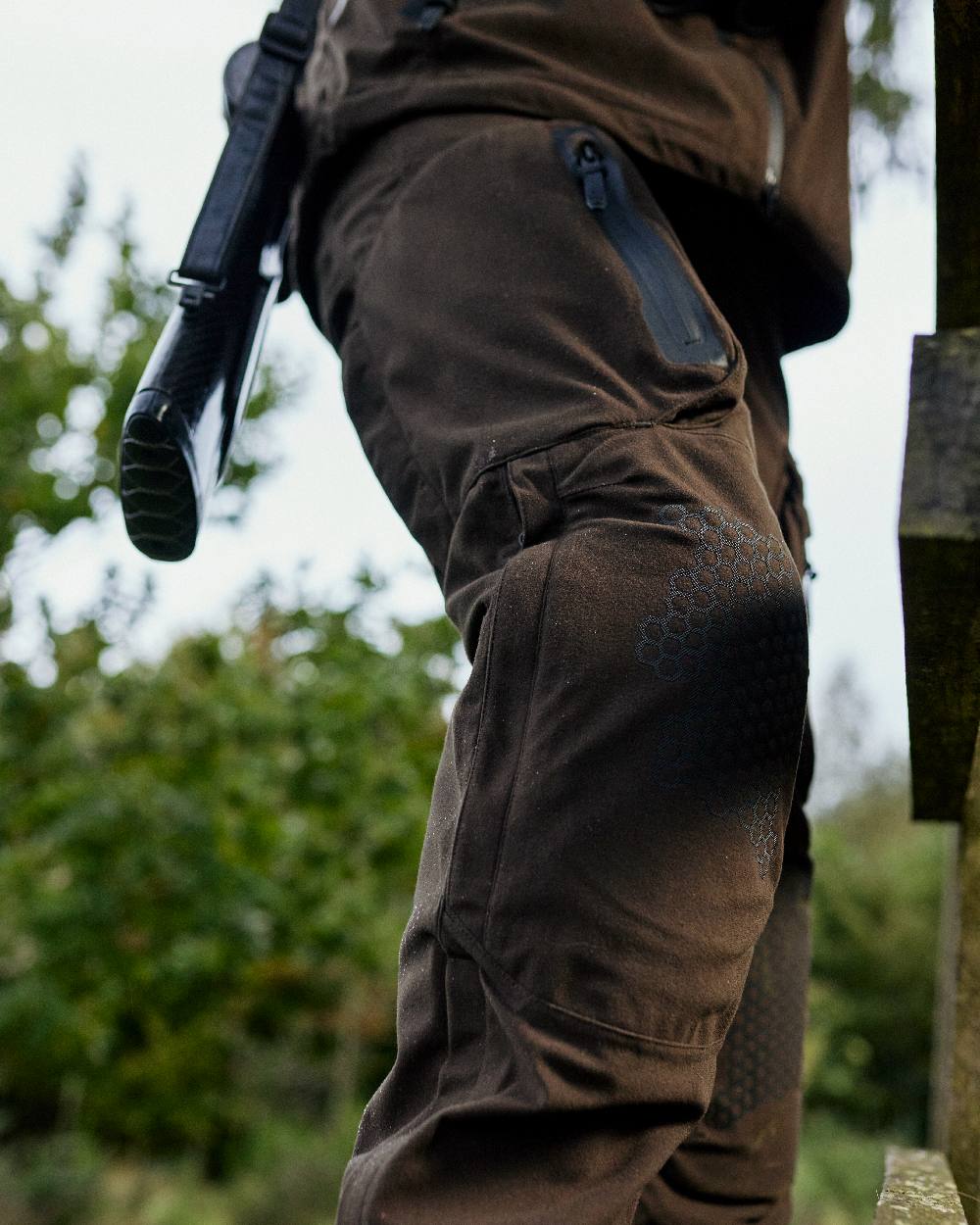 Wood coloured Deerhunter Game Pro Light Trousers on blurry background #colour_wood