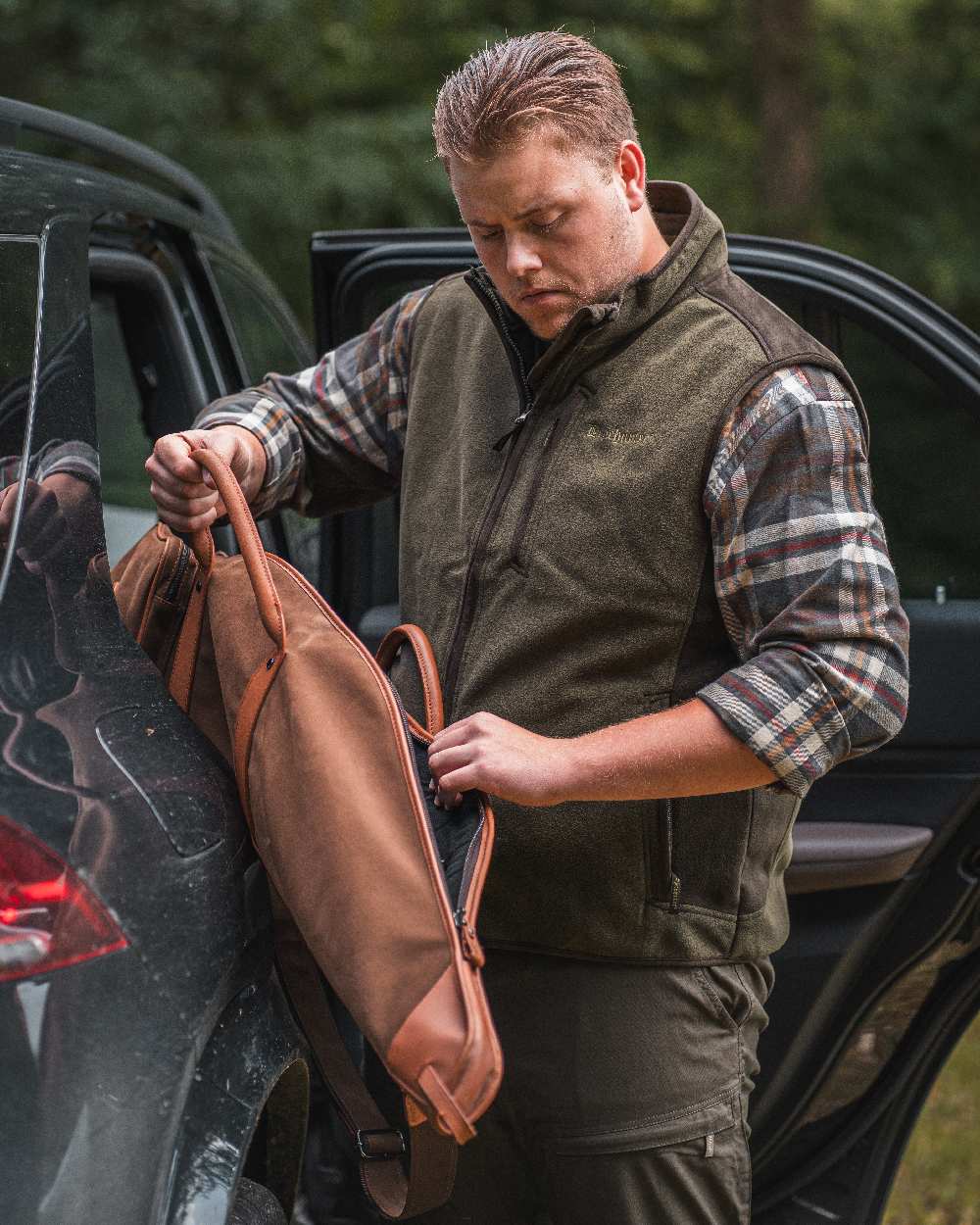 Graphite Green coloured Deerhunter Gamekeeper Bonded Fleece Waistcoat on car background #colour_graphite-green