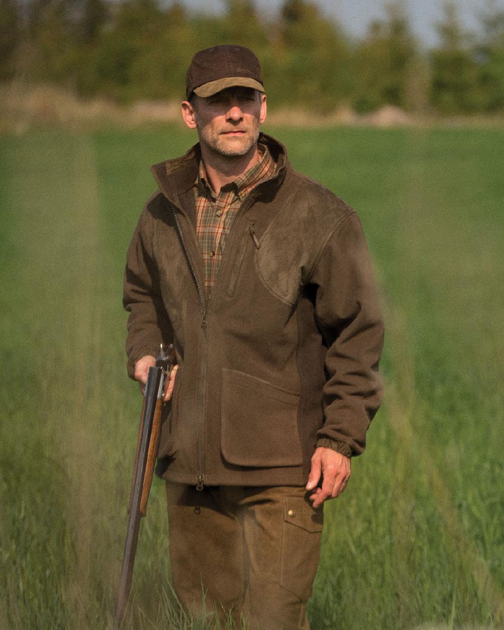 Graphite Green Coloured Deerhunter Gamekeeper Shooting Jacket on grass background #colour_graphite-green