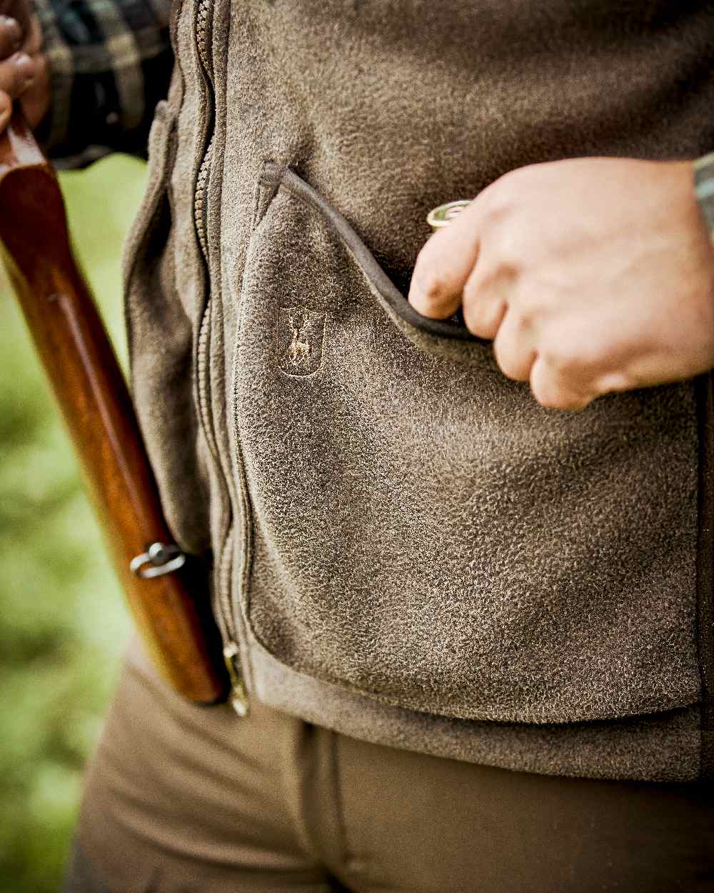 Graphite Green Coloured Deerhunter Gamekeeper Shooting Waistcoat on blurry background #colour_graphite-green