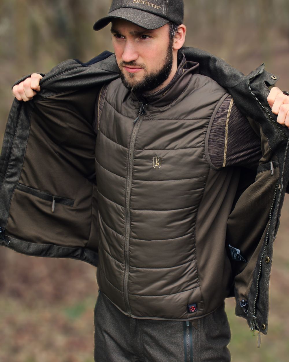 Deep Green Coloured Deerhunter Heat Inner Waistcoat on blurry background #colour_deep-green