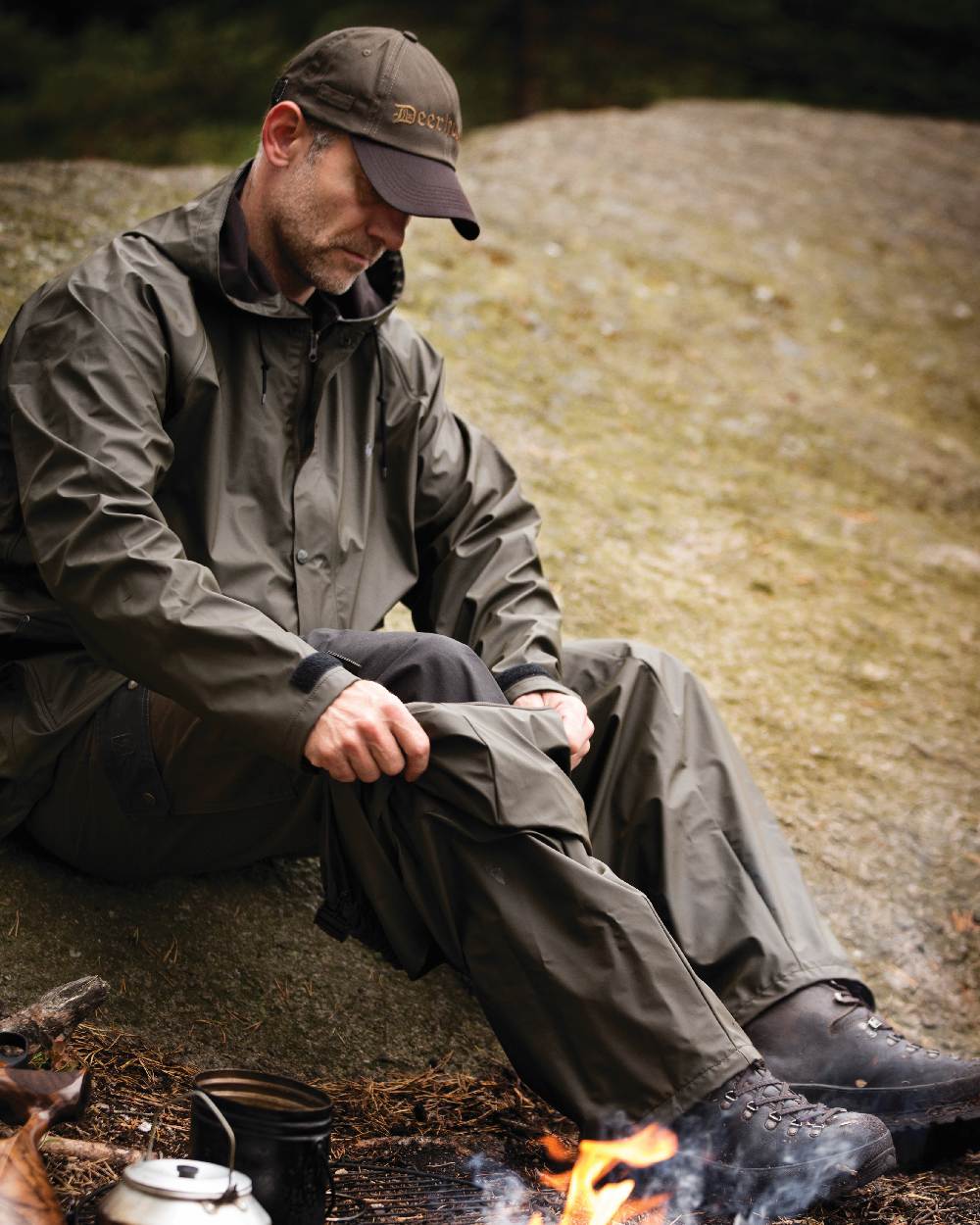 Art Green coloured Deerhunter Hurricane Rain Jacket on rock background #colour_art-green